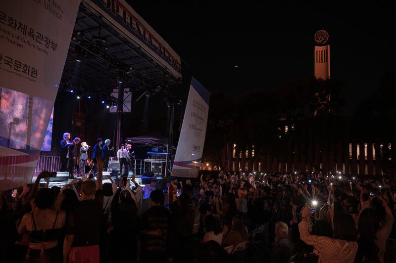 The crowd waves their torchlights as KINGDOM performs “Eternity.” “I am so happy that the event came to fruition after months of hardwork and we can make history in USC again”said Lee Hye-jin, a communications professor at the USC Annenberg School for Communication and Journalism. Lee was  the primary faculty organizer of the event. (Photo by Michael Chow)