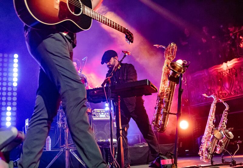 A photo of King playing the keyboard on stage.