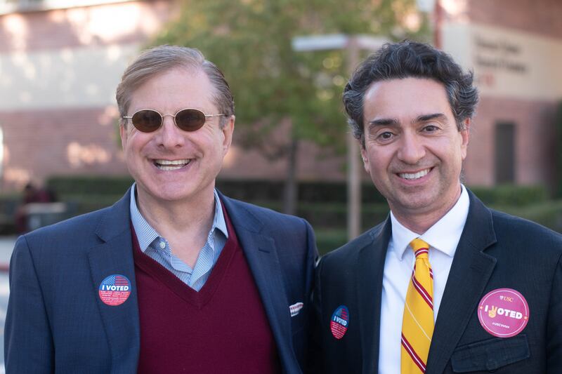 Faculty members Ron Galperin and Kamy Akhavan, the Executive Director for the USC Dornsife Center for the Political Future, proudly display their "I Voted" stickers on USC's campus.