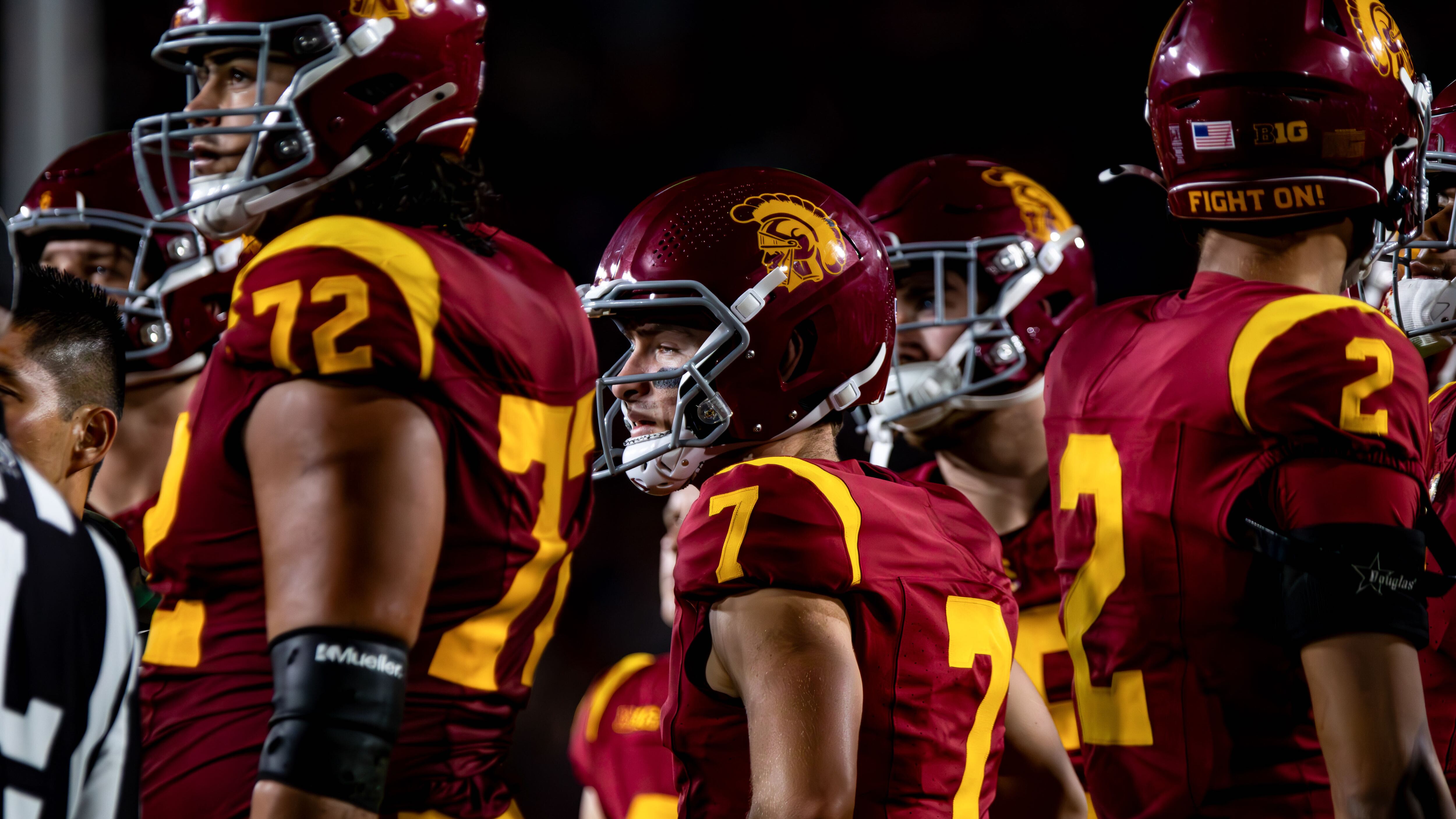A picture of USC's Miller Moss surrounded by his offensive line.