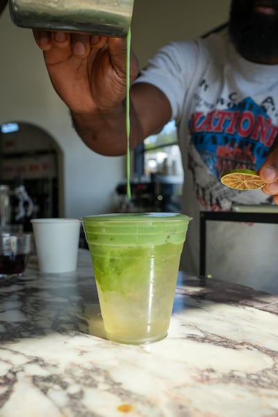 Barista pours a drink.