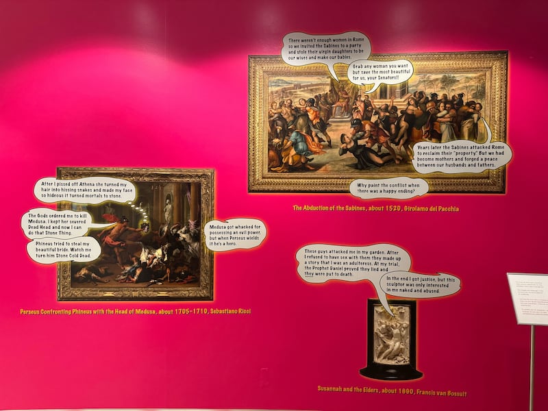 Photo of a bright pink wall features a commission made by the Guerrilla Girls of images of Getty artwork with speech bubbles