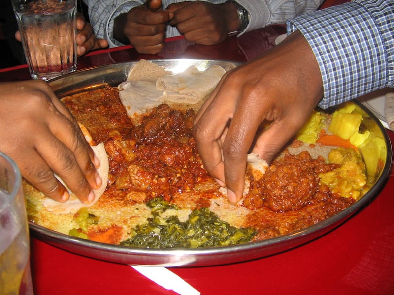 People eating Ethiopian food.