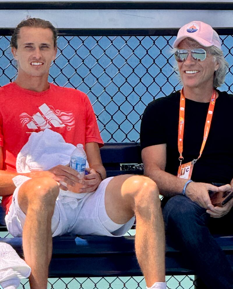 Alexander Zverev taking a break during his Miami Open practice session, seated next to Jon Bon Jovi.