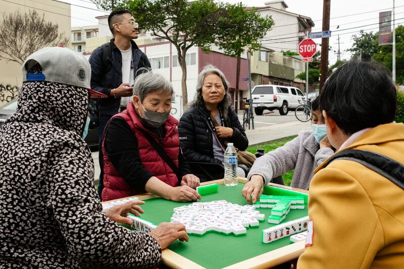 Leung-Astwood watches as other seniors play mahjong outside the Alpine Recreation Center.