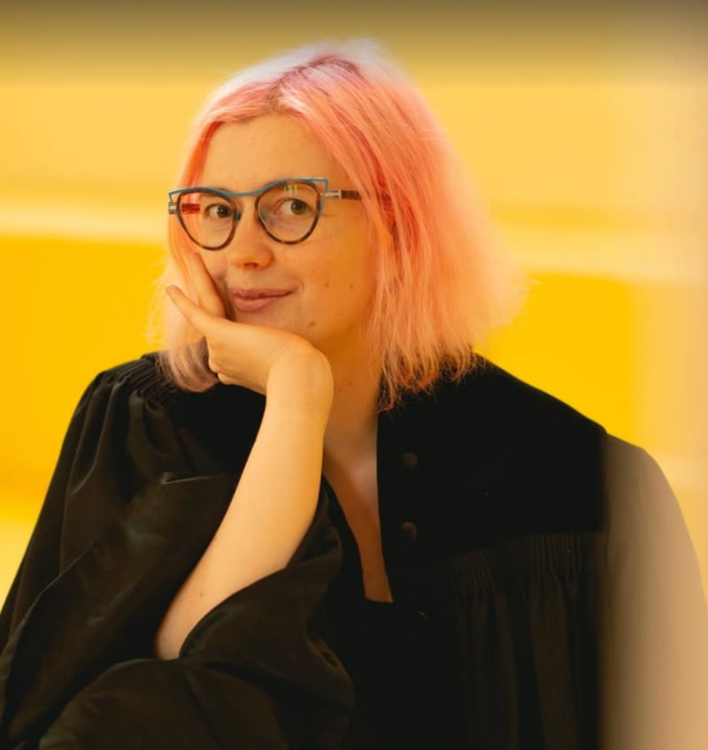 A woman with pink hair.