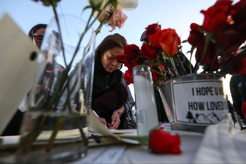 Kamala Harris brings flowers to the Monterey Park vigil after a mass shooting at a local dance studio.