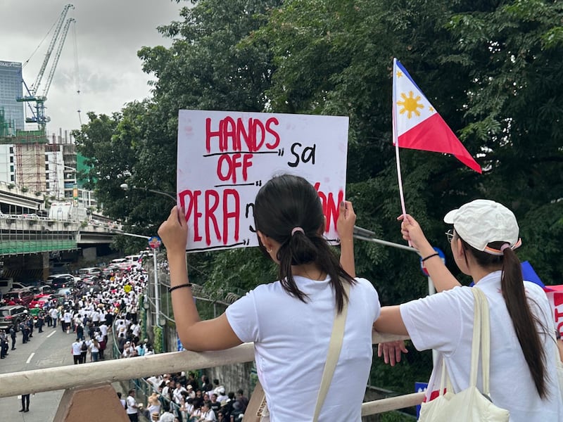 Protesters holding a sign