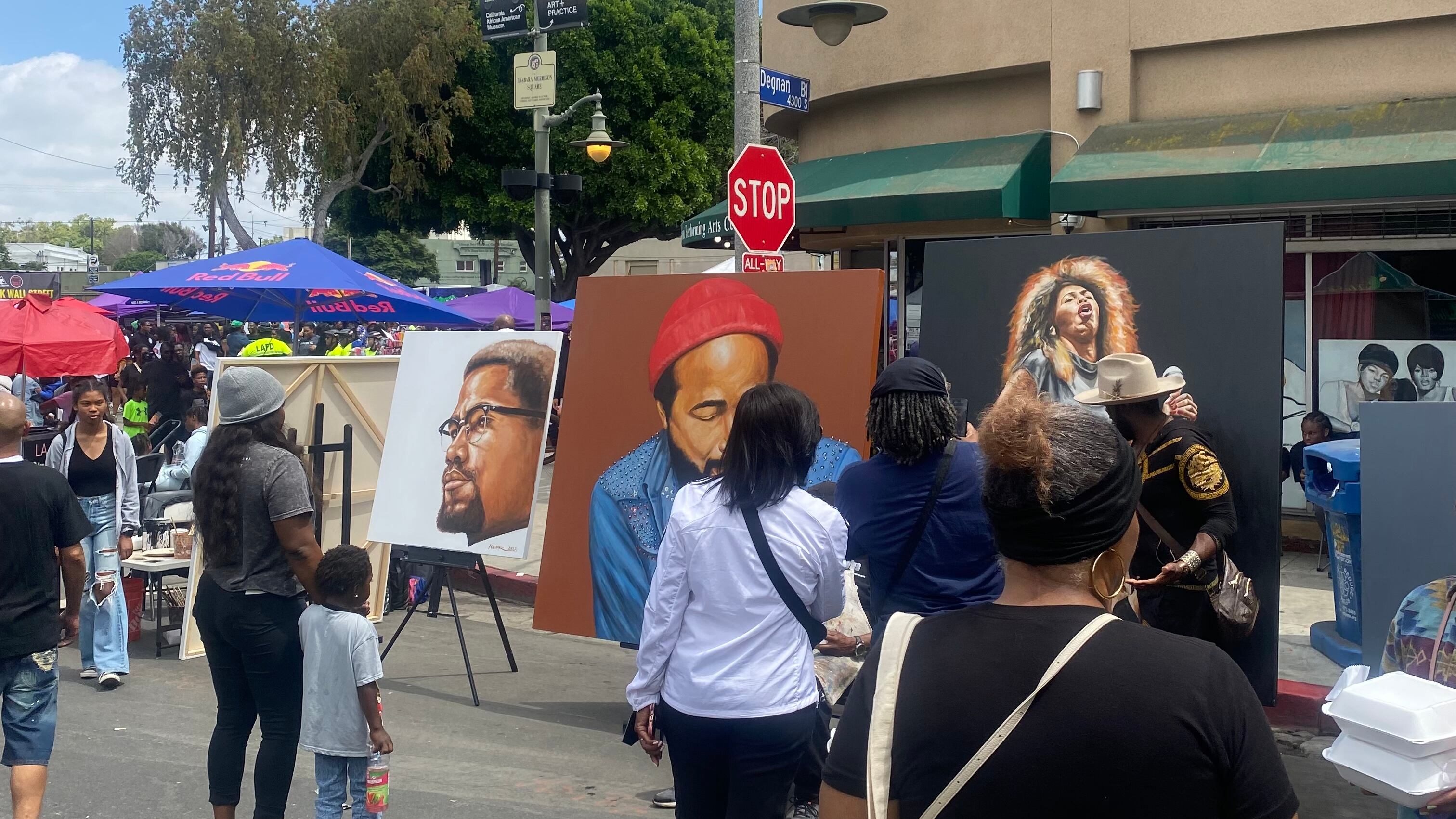 Photo of people looking at artwork at the Leimert Park Juneteenth Festival.