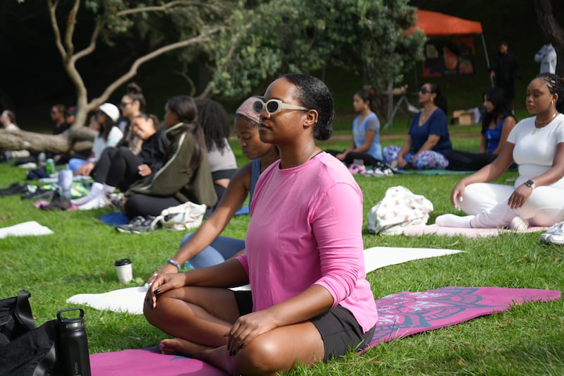 Participants move through a yoga sequence during WalkGood LA × BeyGOOD’s final BreatheGood of the year at Kenneth Hahn Park on November 2.