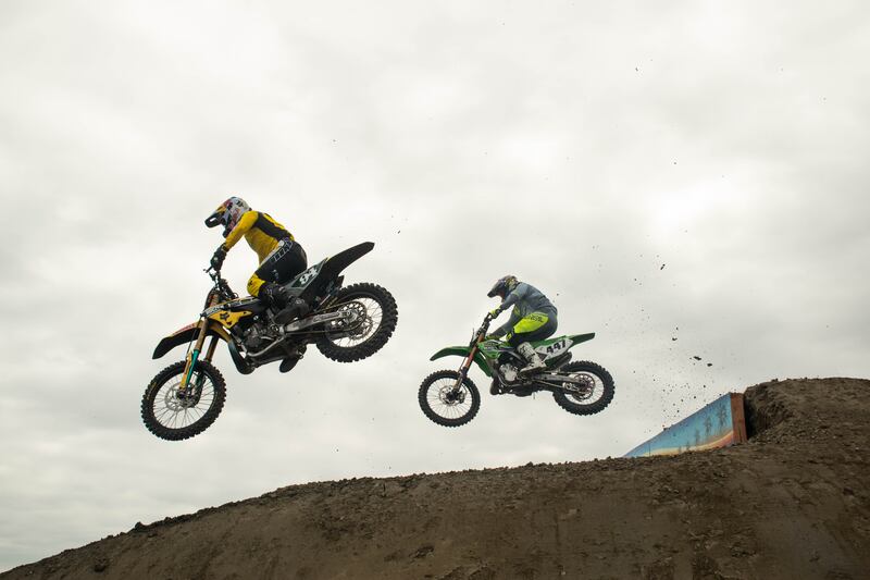 Ken Roczen (left) and Deven Raperat (right) flying through the air in the first round of Straight Rhythm competition. Roczen defeated Raperat and placed second overall in the 250cc category.