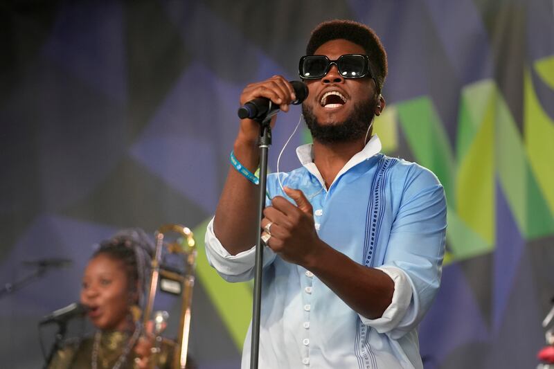 Photo of a man singing on stage.