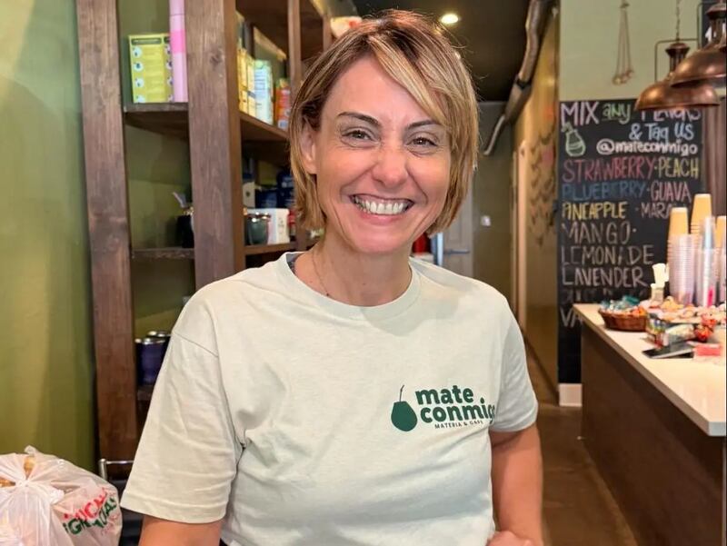 Photo of a woman wearing a green t-shirt and smiling.