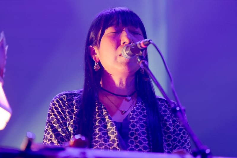 Musician singing into a microphone