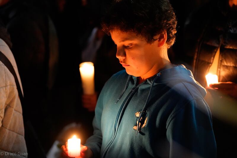 Photo of a young boy holding a candle