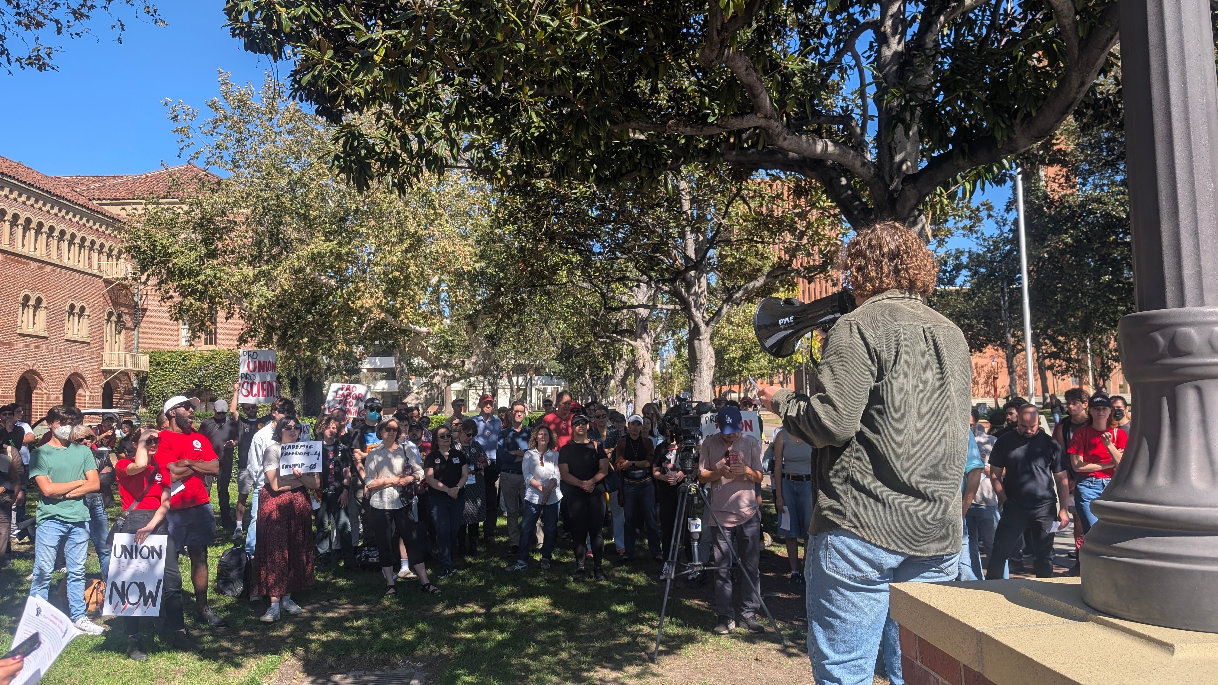 Faculty and staff rally near the Tommy Trojan statue on Oct. 17, 2025.