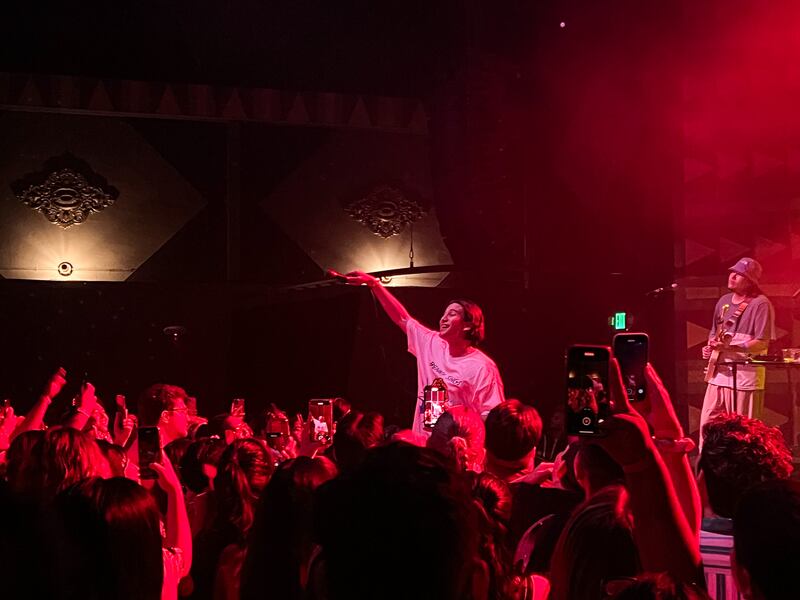 Photo of a man standing over a crowd