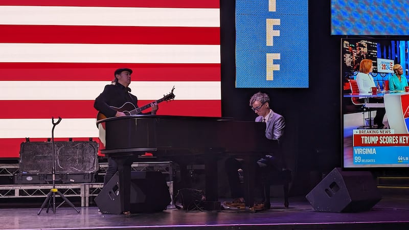 Live music performers tune their instruments and conduct mic checks of pop songs.