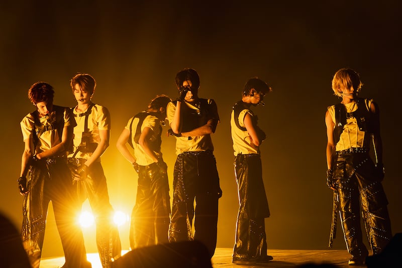 Guy group on stage performing