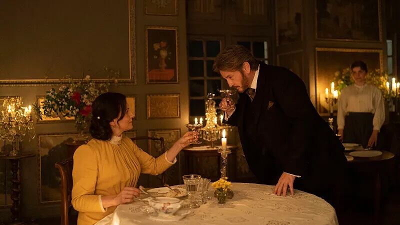Juliette Binoche and Benoît Magimel clinking their wine glasses in "The Taste of Things"