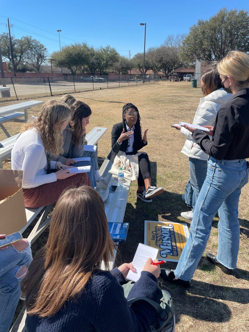 Volunteers from Our Revolution show reporters their app to canvass the neighborhood. Jessica Mason, center, speaks to reporters in South Dallas. (Photo by Christina Bellantoni)
