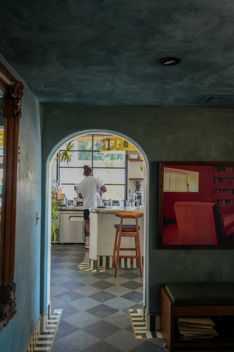 Barista photographed through an arch.