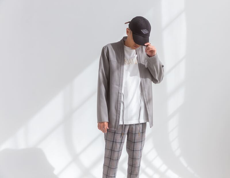 Man in jacket and hat standing