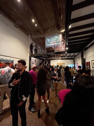 Photo of patrons standing in the "My Homies" exhibit in DTLA on opening night.