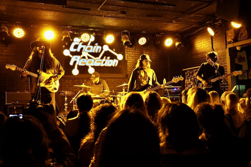 Band on stage with yellow lights