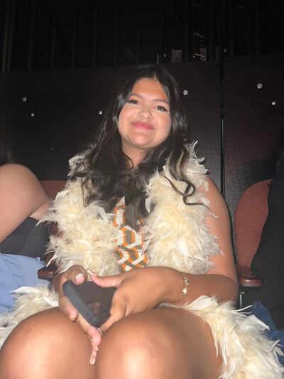 A photo of Gutierrez posing in a feather boa at the concert.