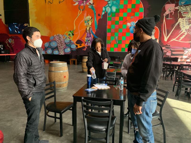 A photo of an organizing director meeting with activists after canvassing.