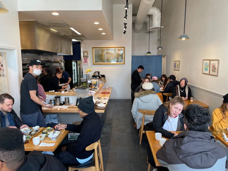 Photo of customers eating inside a restaurant