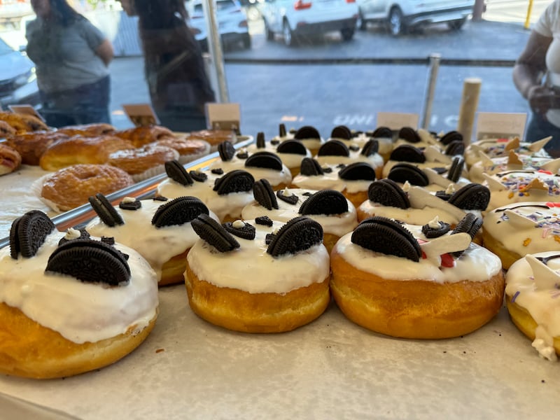 Photo of donuts with white glaze and Oreo cookies to resemble a panda