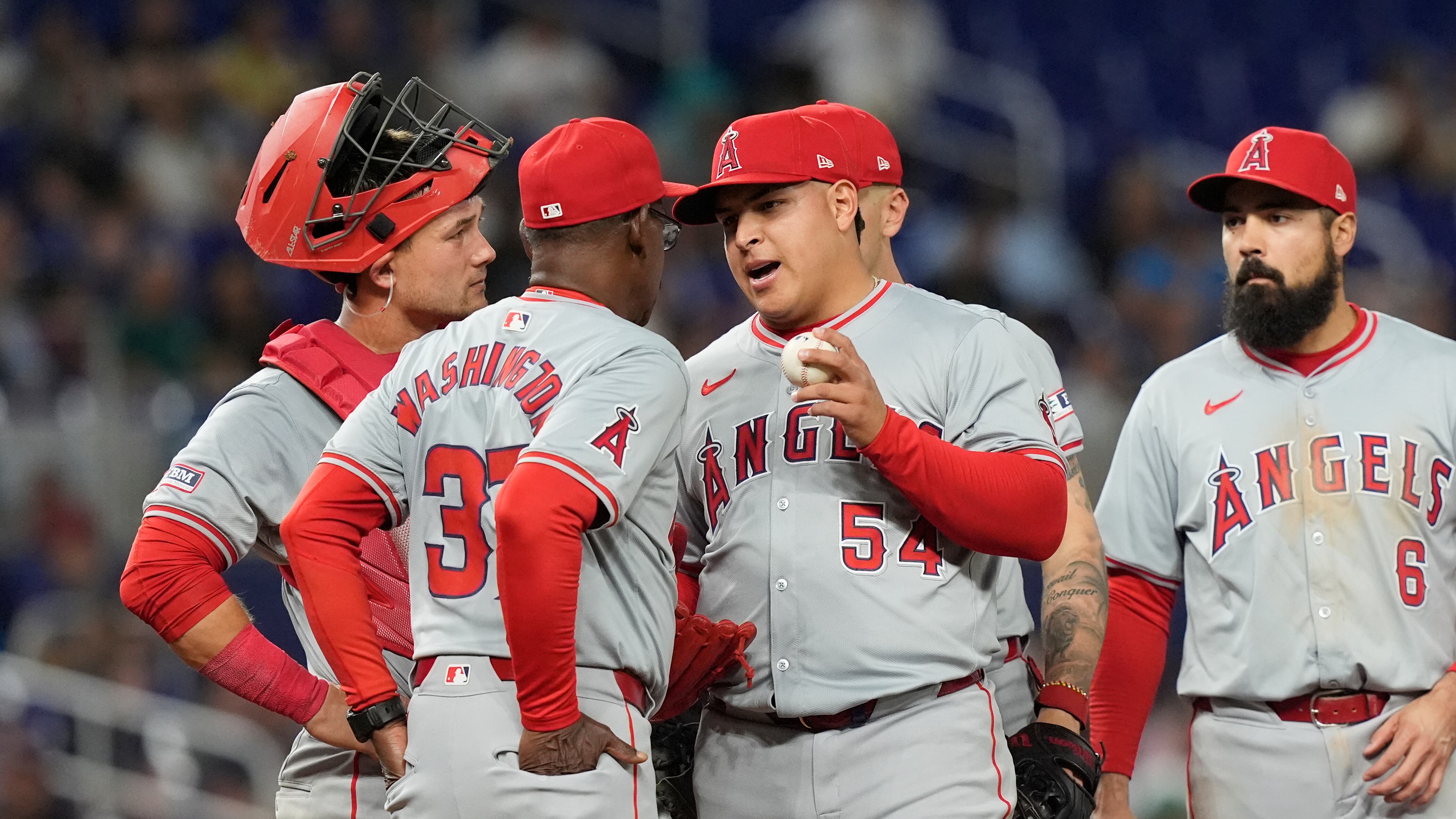 Los Angeles Angels pitcher Jose Suarez, wearing number 54 in gray with red trim and a red hat, talks to manager Ron Washington on the pitching mound before he is relieved during the sixth inning of a baseball game against the Miami Marlins, Monday, April 1, 2024, in Miami. (AP/Marta Lavandier)
