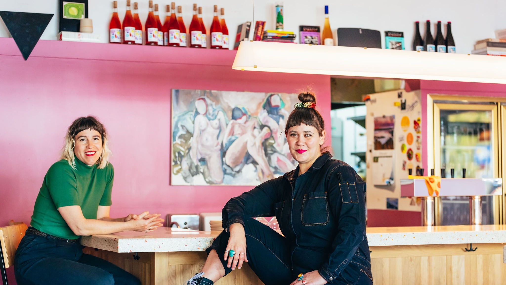 Two women sit at a bar inside The Ruby Fruit.