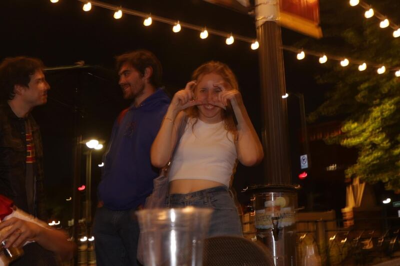 Woodworth motions like she's taking a photo outside at Rock and Reillys.