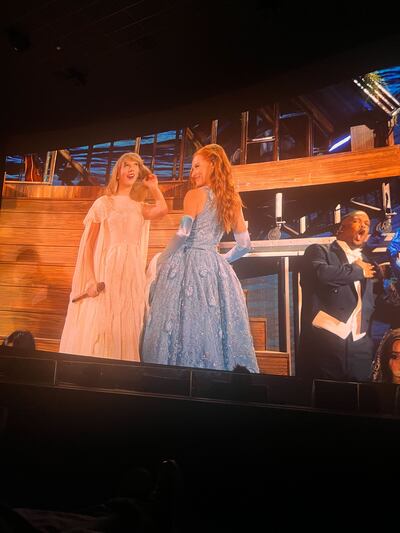 A photo of Taylor Swift on the screen at the movie theatre.