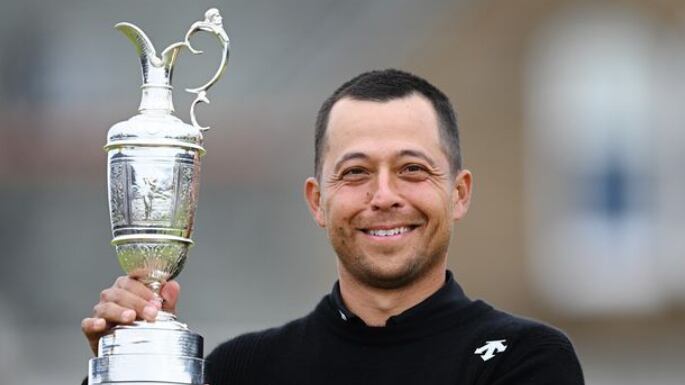 Xander Schauffele hoists the Claret Jug.