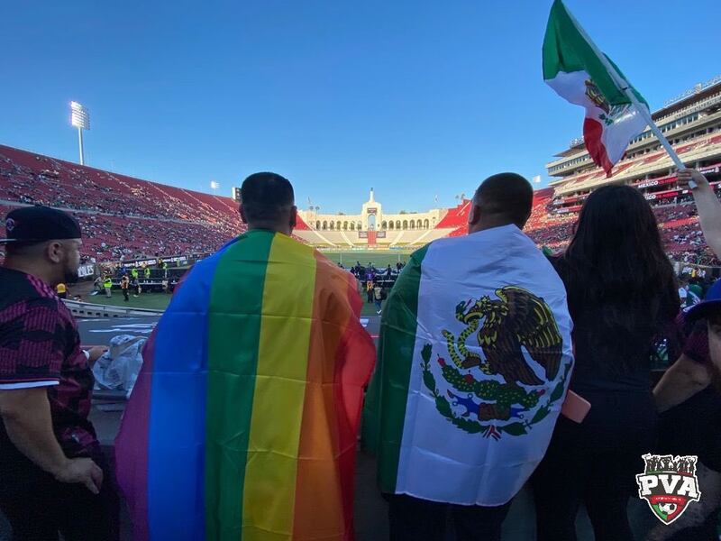 Members of Pancho Villa's Army wave Pride flags during a friendly between Mexico and Nigeria at the L.A. Memorial Coliseum on Saturday, July 3, 2021.