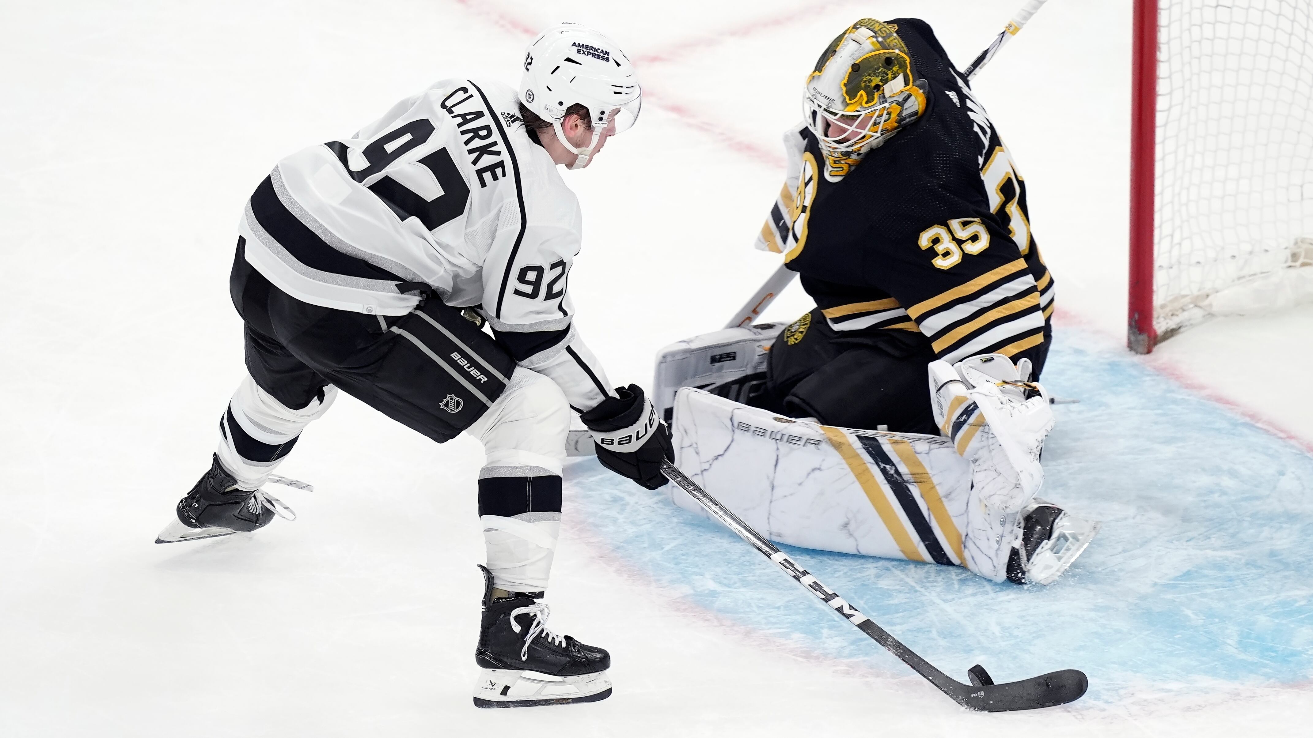 Los Angeles Kings' Brandt Clarke, wearing number 92 in white, sets up to score on Boston Bruins' Linus Ullmark, wearing number 35 in black with yellow trim, in overtime during an NHL hockey game, Saturday, Feb. 17, 2024, in Boston. (AP/Michael Dwyer)