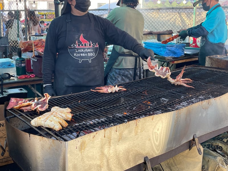 Photo of a person grilling a squid