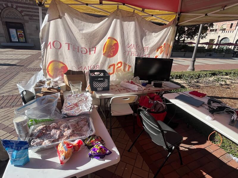 An awning set up with tables and food for statue security