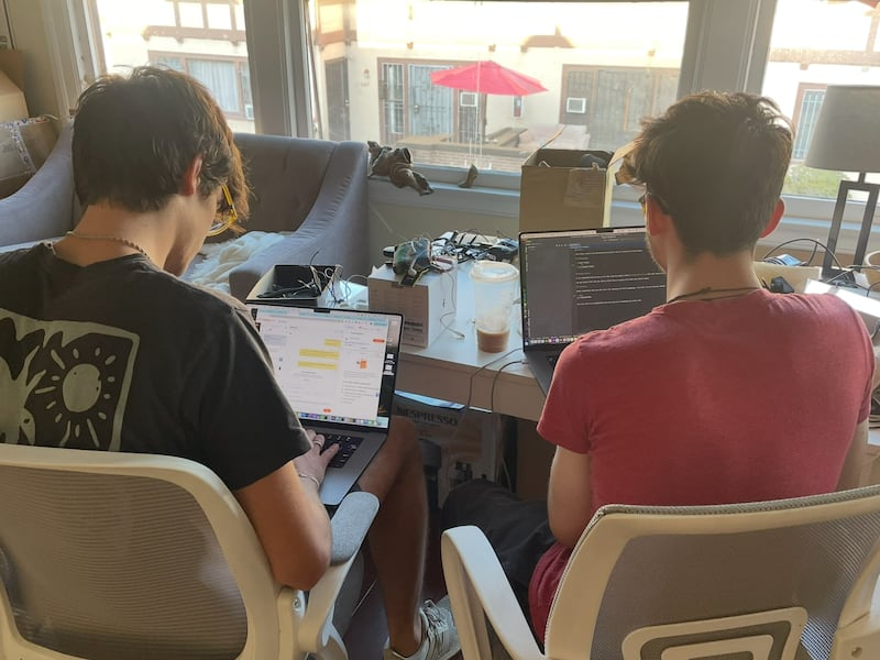 Photo of Henry Fox, left, and Henry Warren, right, working on Sidekick in their dorm room. (Photo courtesy of Henry Fox)