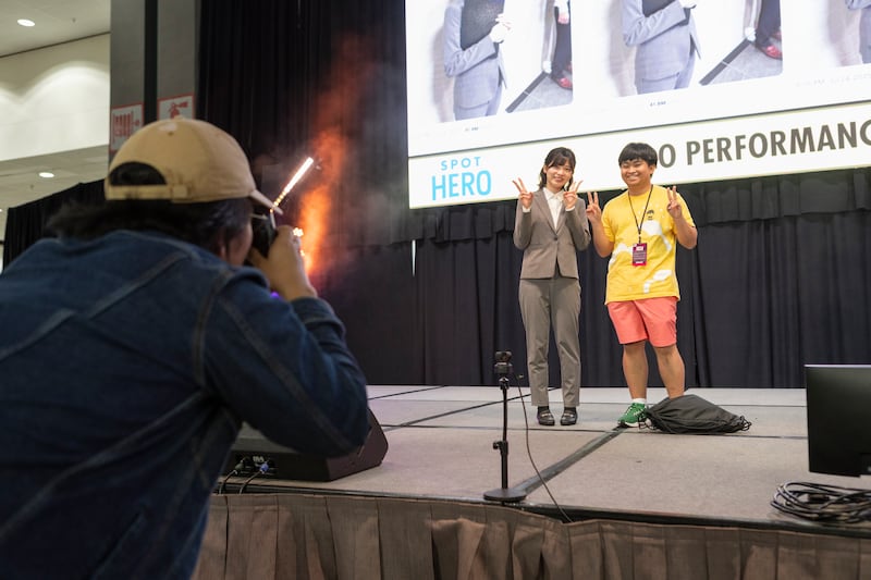 Saori Araki taking pictures with a fan