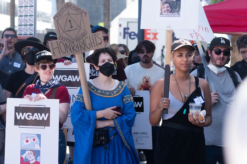 An actor dressed up as an elf listens to a speech at the strike.