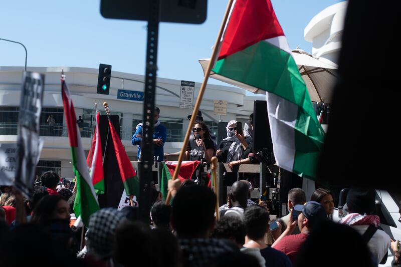 Speakers or organizers at the "All Out For Gaza" protest in front of the crowd.
