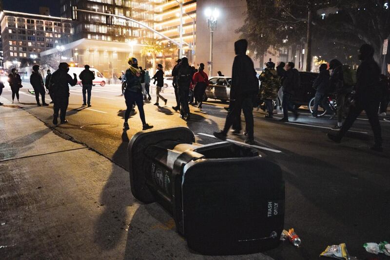 [Photo of trash can in the street during protest.]