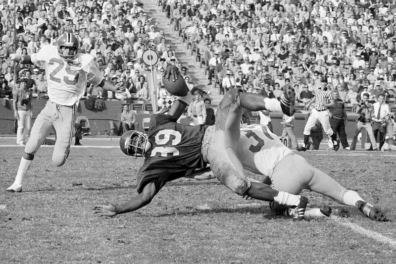 Southern California fullback Sam Cunningham (39) is brought down by Washington State's Eric Johnson after picking up 16 yards at the Los Angeles Coliseum in Los Angeles.
