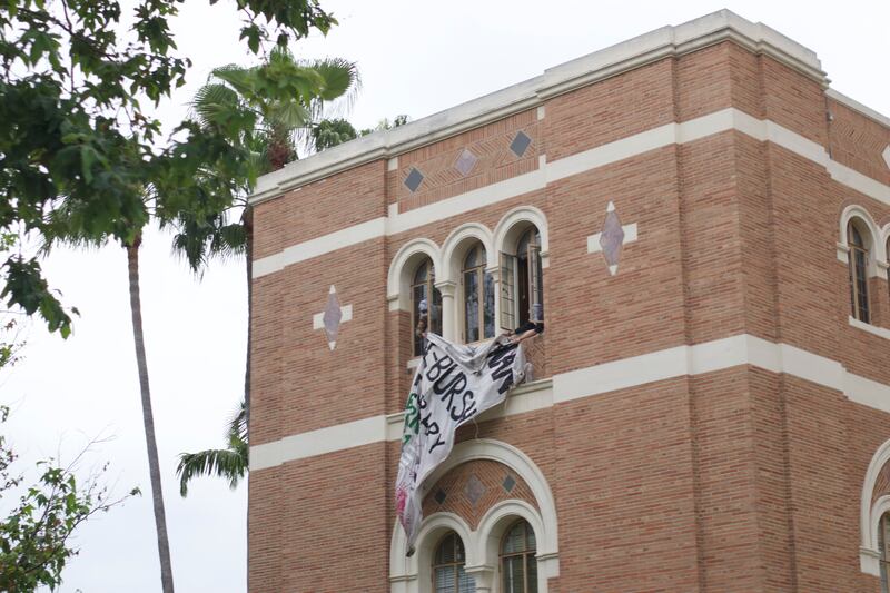 a white banner hanging from doheny library