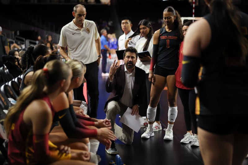 Head coach Brad Keller in huddle with USC women's volleyball.